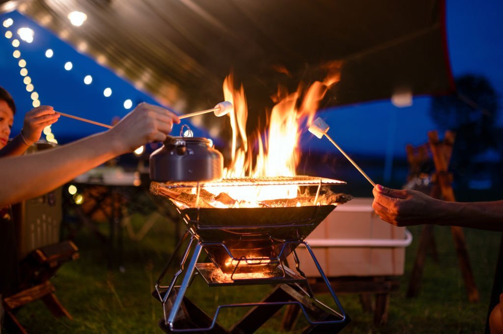 Roasting marshmallows during an event in a campground