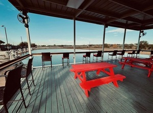 It’s a welcoming outdoor space perfect for relaxing, socializing, or catching a game on the TV.